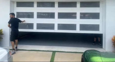 Quick Springs technicians installing and balancing modern white glass panel garage door