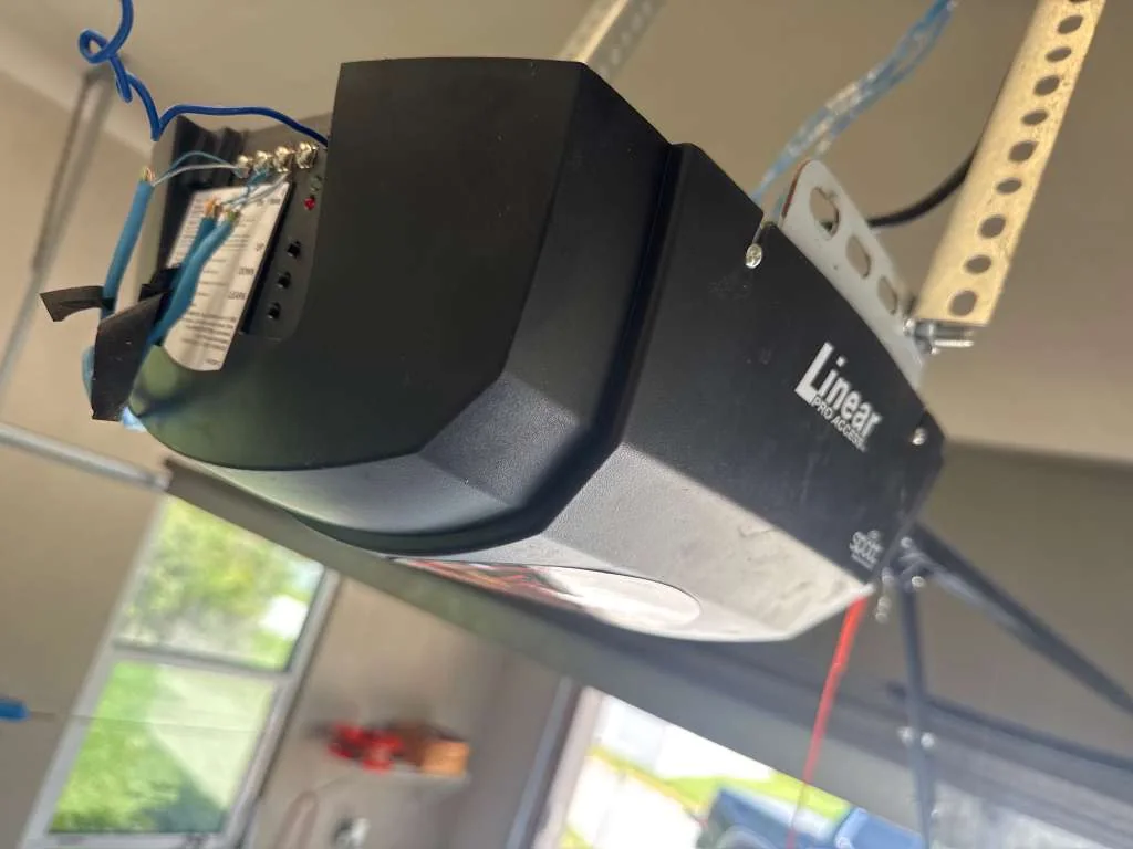 Linear Pro Access ceiling-mounted garage door opener motor head installed with safety wiring