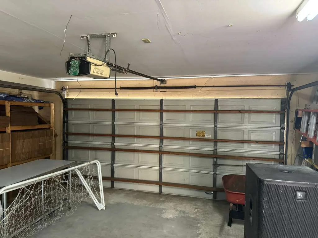 Older ceiling garage door opener with casing removed exposing internal logic board and wiring