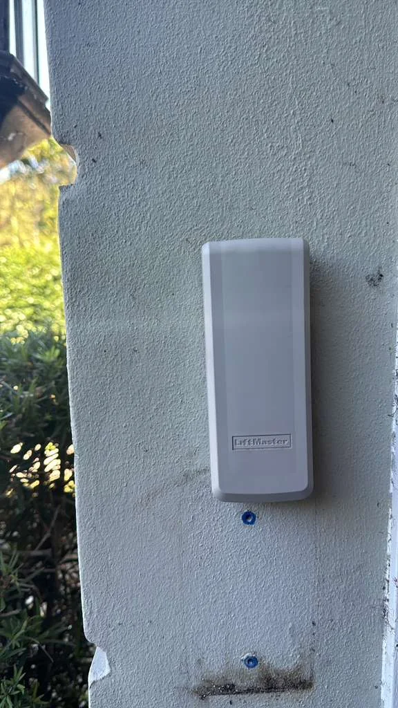 LiftMaster outdoor wireless digital keypad mounted to exterior home stucco wall