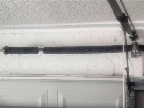 Broken garage door torsion spring snapped in two across shaft before replacement