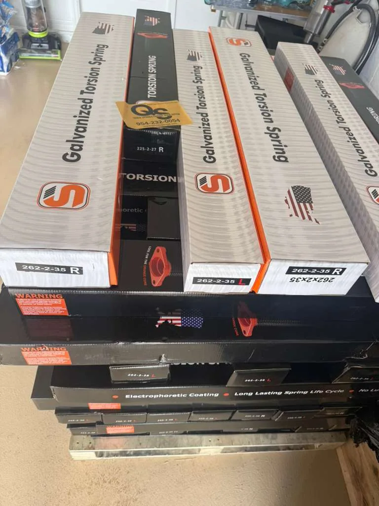 Boxed heavy-duty galvanized torsion springs with Quick Springs Garage Door Repair business card