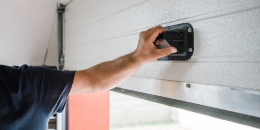What are the steps to manually open a garage door if the opener is not working?